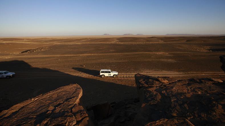 A UN car drives through the open desert UN Team Navigates through Western Sahara copy