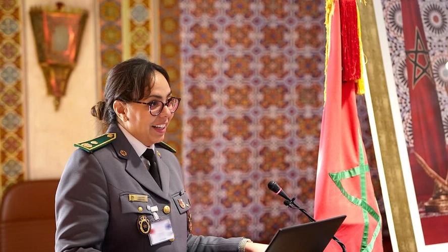 A woman in uniform stands at a podium