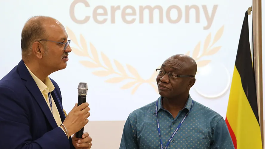 Chief FSDH, Sanjay Khanna (l) delivers his appreciation of James Nsoh's (r) dedication and work ethic.