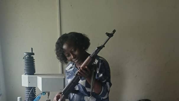 a woman is holding a gun