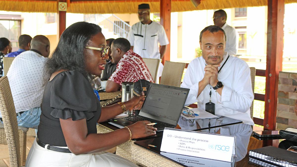 Chief LARRMU, Elise Metougue takes International Payroll and Benefits Service Line Manager, Manaswee Vaidya, through his checklist for ISO 9001:2015 documentation