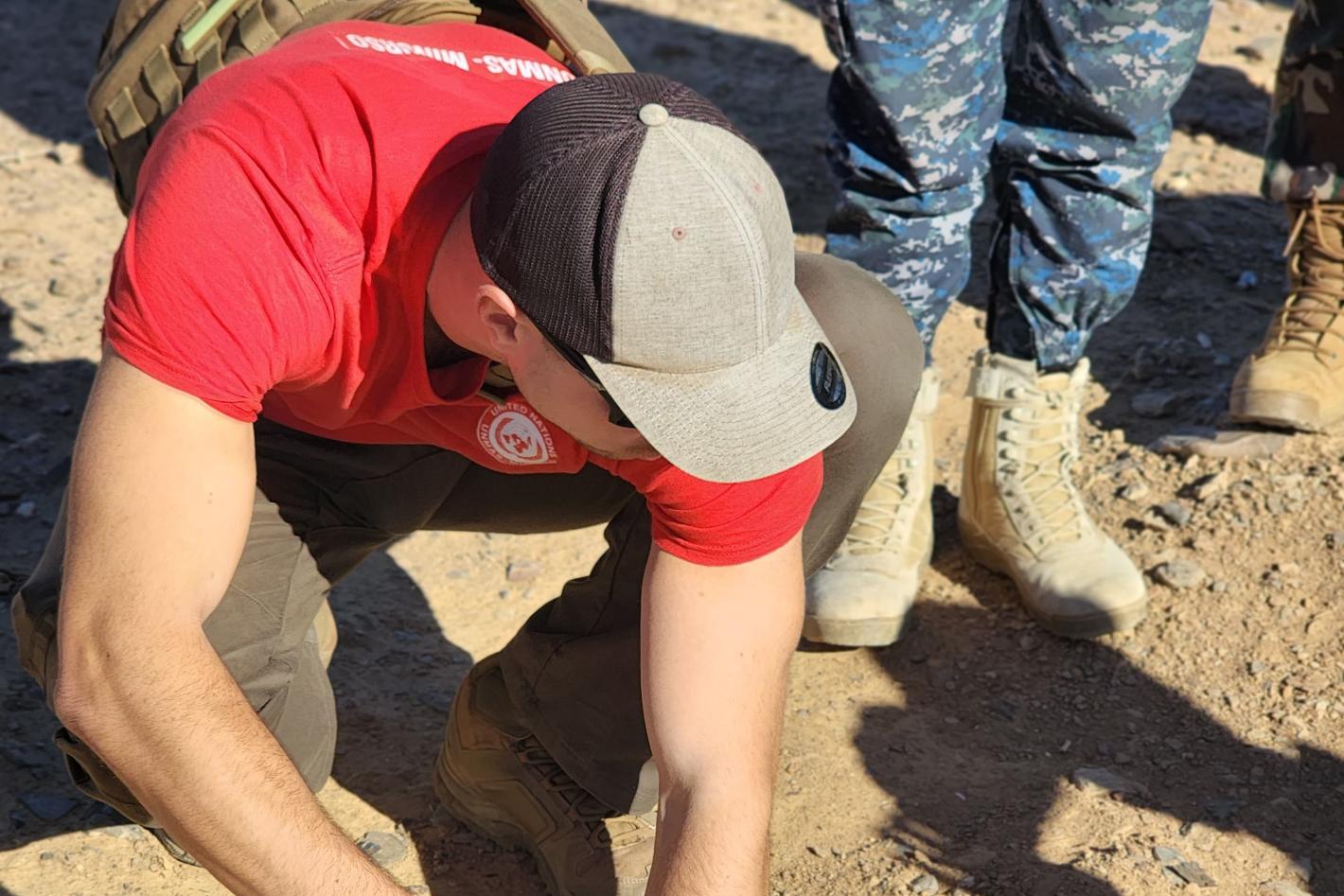a man is measuring the with of a hole on the ground