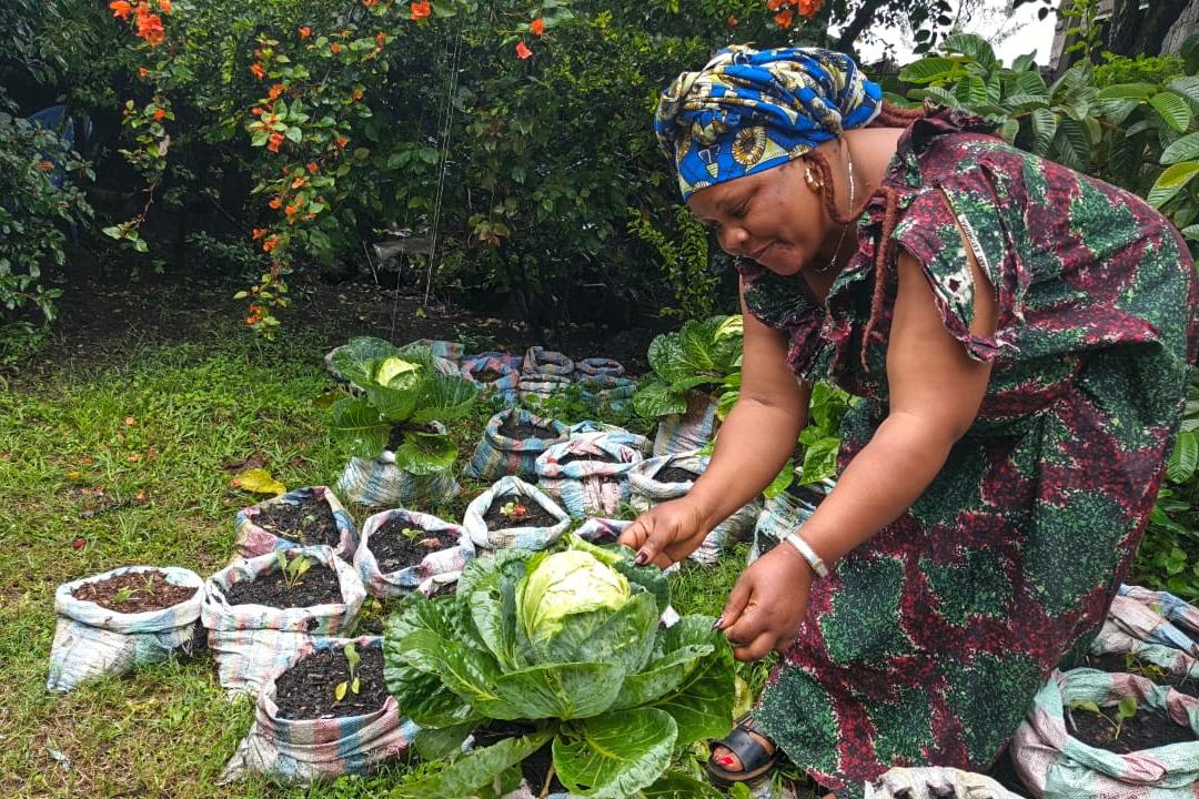 a woman is working in a garden