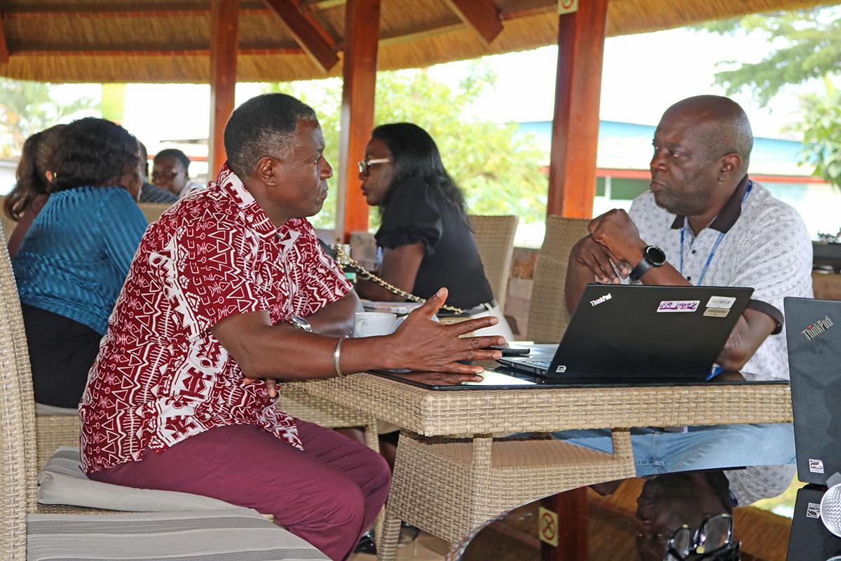 Chief of Regional IT Security Unit, Michael Mwaura (l) talks with ISO Consultant